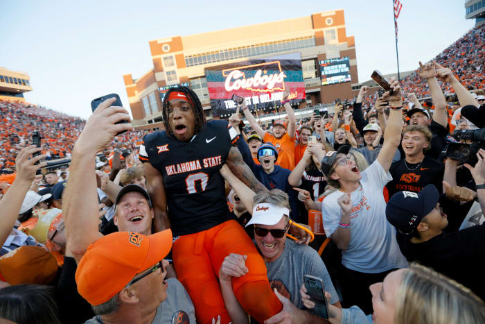 Oklahoma State Cowboys running back Ollie Gordon II (0) celebrates with fans after a Bedlam college football game between the Oklahoma State University Cowboys (OSU) and the University of Oklahoma Sooners (OU) at Boone Pickens Stadium in Stillwater, Okla., Saturday, Nov. 4, 2023. Oklahoma State won 27-24.